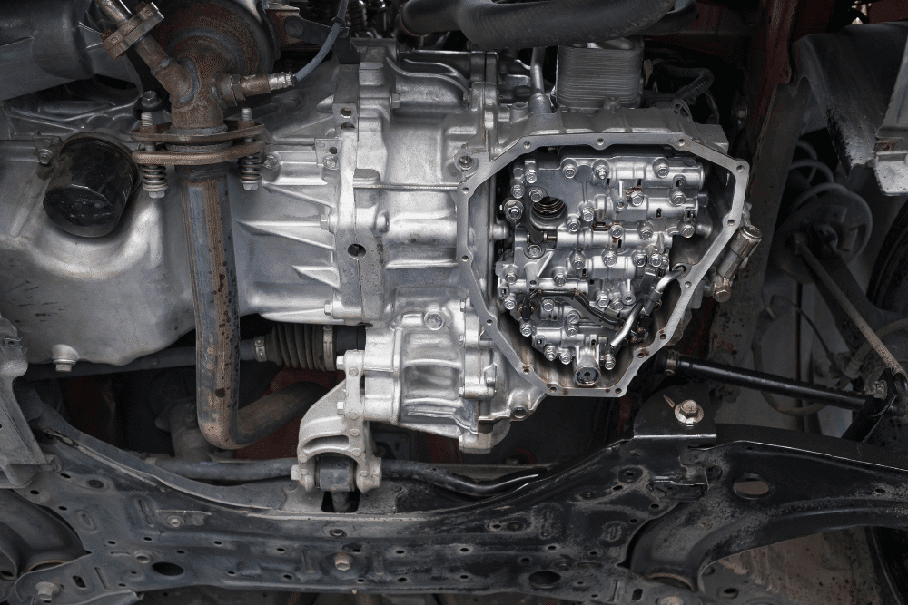 Transmission service in Englewood, CO by Autovisions. Image of an exposed vehicle transmission with the pan removed, showing internal components during a professional transmission inspection and repair to restore smooth shifting and reliable performance.