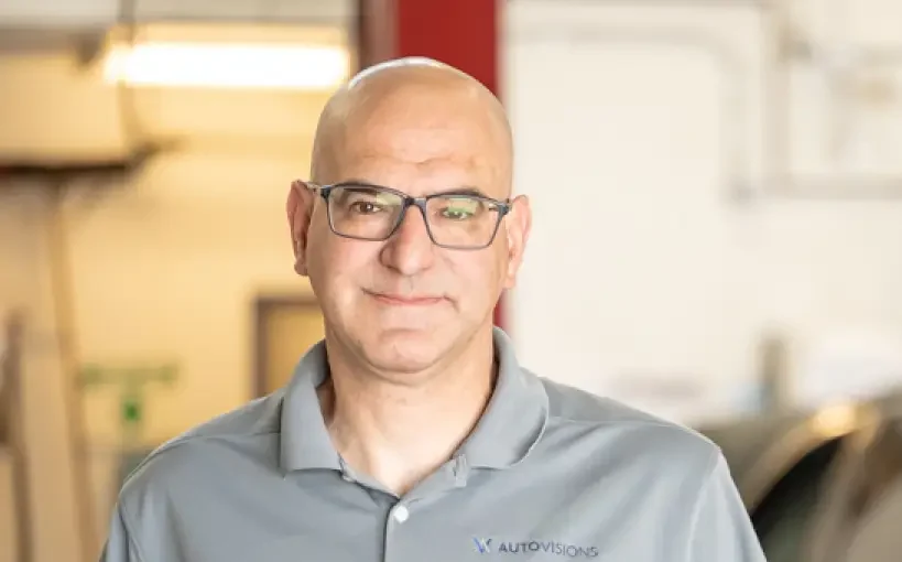 Image of Autovisions' owner Nathan Bryant wearing collared gray shirt.