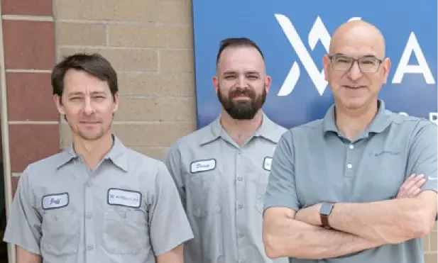 auto repair careers, Auto repair in Englewood, CO at Autovisions. Image of Nathan Bryant and his 2 colleagues standing outside of the shop, wearing uniforms, showcasing professionalism and dedication to quality auto repair services.