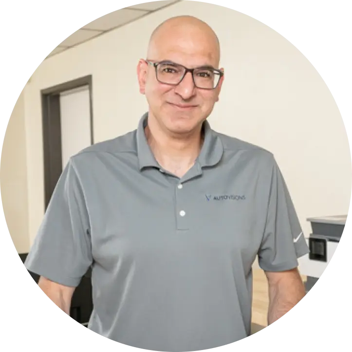 Image of Autovisions' owner Nathan Bryant wearing collared gray shirt.